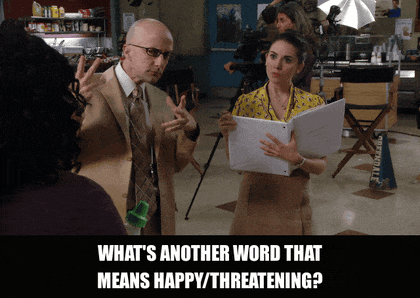 Jim Rash in Community (2009), captioned "What's another word that means happy/threatening?", Confused and Earnest reaction animated GIF