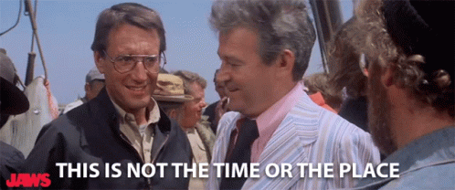 Murray Hamilton and Roy Scheider in Jaws (1975), captioned "This is not the time or the place", Defensive and Tense reaction animated GIF