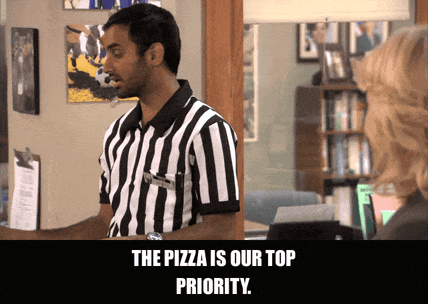 Aziz Ansari in Parks and Recreation (2009), captioned "The pizza is our top priority.", Confident and Excited reaction animated GIF