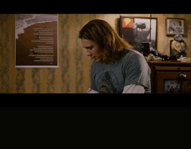 James Franco and Seth Rogen in Pineapple Express (2008), captioned "What's up with the suit? Oh, I'm a process server, so I have to wear a suit.", Curious and Deadpan reaction animated GIF