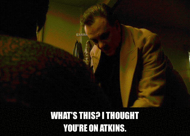 Denise Borino-Quinn and Vincent Curatola in The Sopranos (1999), captioned "What's this? I thought you're on Atkins. I was. I am. It's hard, John. I'm trying.", Awkward and Nervous reaction animated GIF